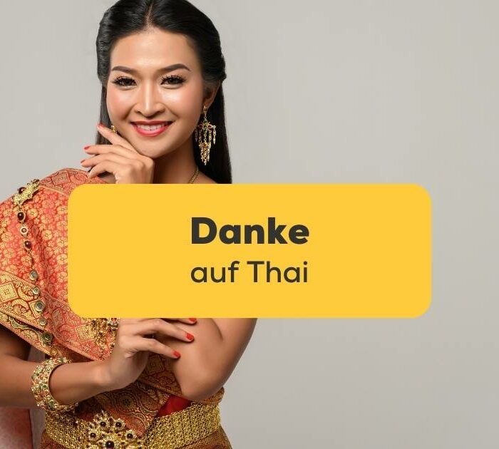 Thailändische Frau in traditioneller Kleidung und sagt Danke auf Thai