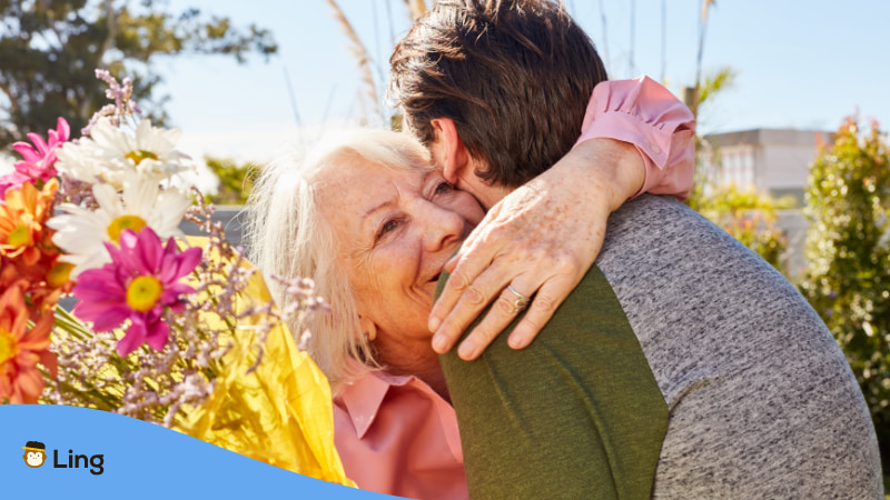 Saying Thank you in Tagalog To Older People - A photo of an elder woman hugging a younger man