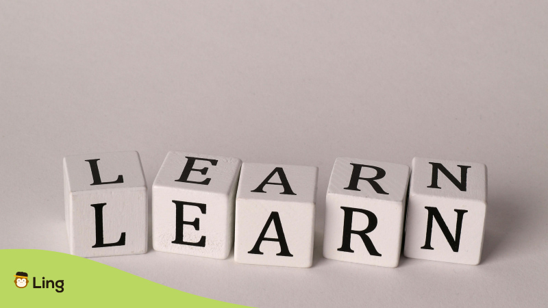 Wooden Blocks Spelling Out The Word “Learn” Arranged On A Neutral Background