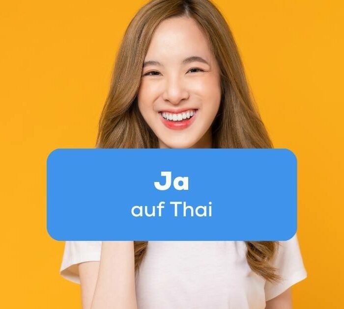 Thai Frau lächelt und freut sich und will ihre Zustimmung mit Ja auf Thai sagen