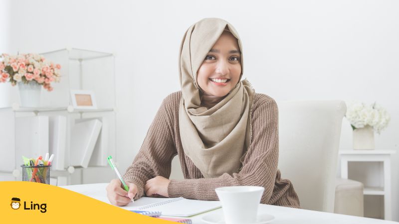 Malay Woman Writing Note On A Desk_Malay Proverbs