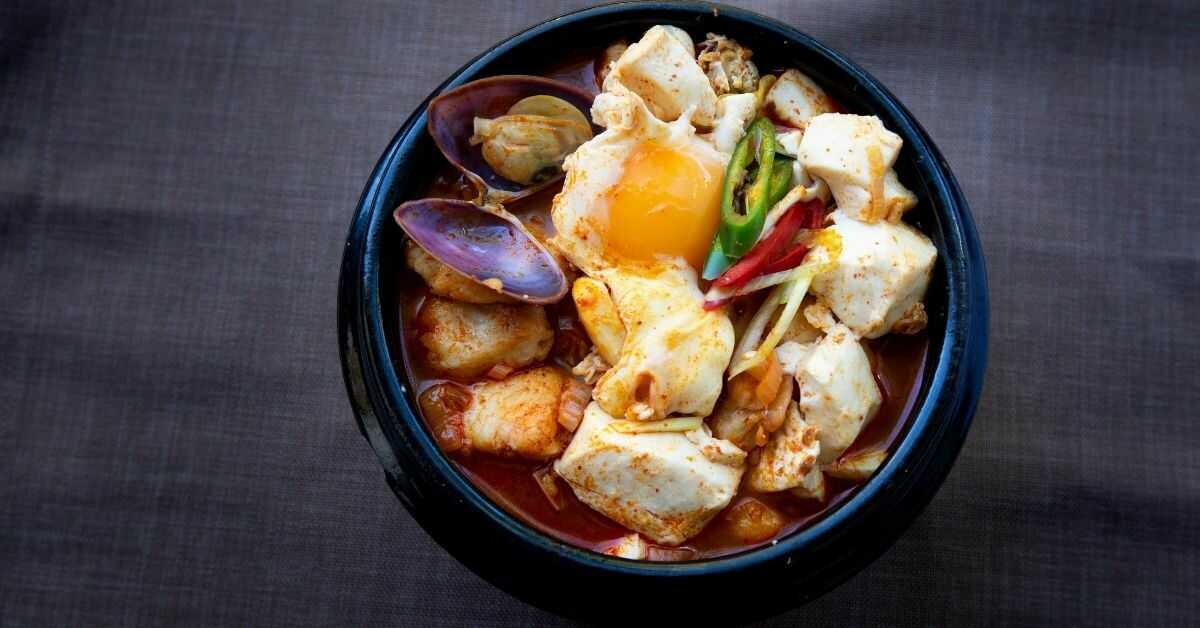 Bowl with Korean Food Spicy Soft Tofu Stew 순두부찌개 Sundubu Jjigae