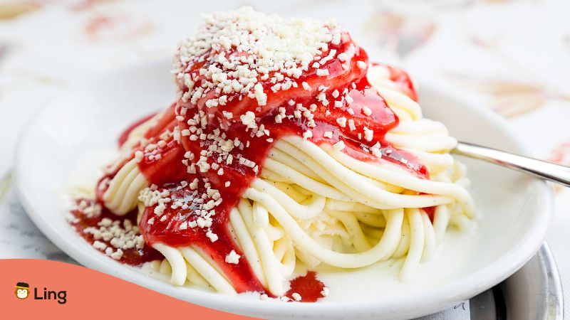 German modern dessert Spaghettieis made from Vanilla icecream and strawberry sauce resembling italien noodles with red tomatosauce