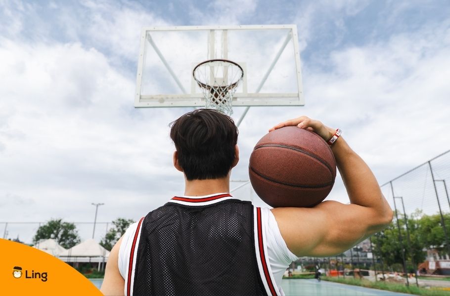 Basketball Player Looking At Basketball Hoop With Ball On Shoulder