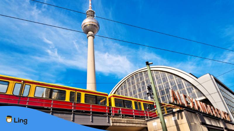 View of TV tower and train arriving at train station Alexanderplatz in Berlin Germany