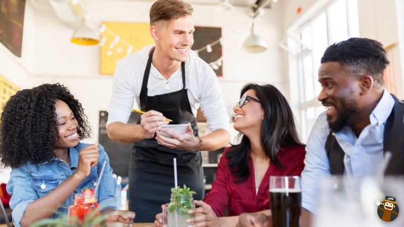 waiter attending to customers in a restaurant