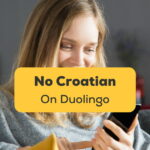 Woman looking on her phone and wondering why there is No Croatian On Duolingo