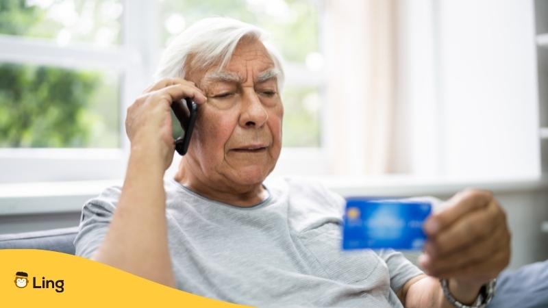 Ore-Ore-Sagi-Scam-Ling-App-old-man-talking-on-the-phone-holding-credit-card