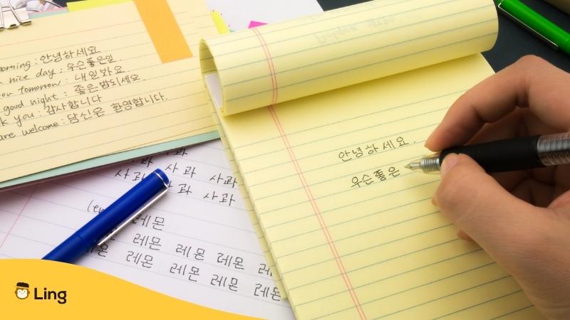 korean alphabet korean letters - person writing in Korean - hangul