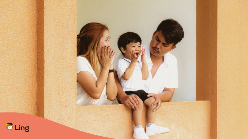 Tagalog Tongue Twisters - A photo of a mother and father looking at their son