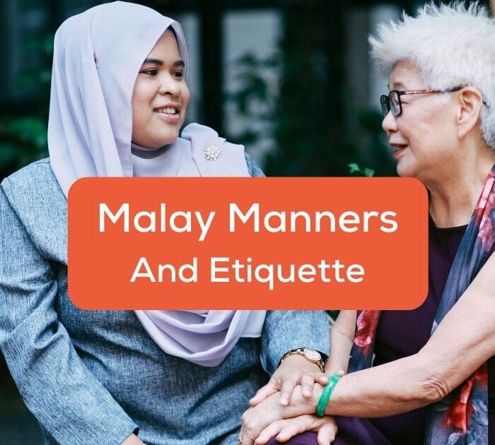 Malaysian woman showing manners and etiquette while talking to an elder.