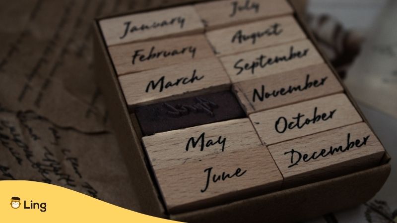 Bosnian Days And Months. Wooden blocks in a box with the names of the months of the year written on them.