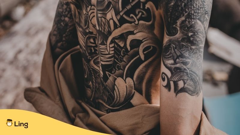 Khmer Tattoo. Back and arms of a man with a large tattoo design in black.