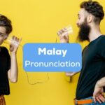 Tourist couple learning Malay pronunciation together.