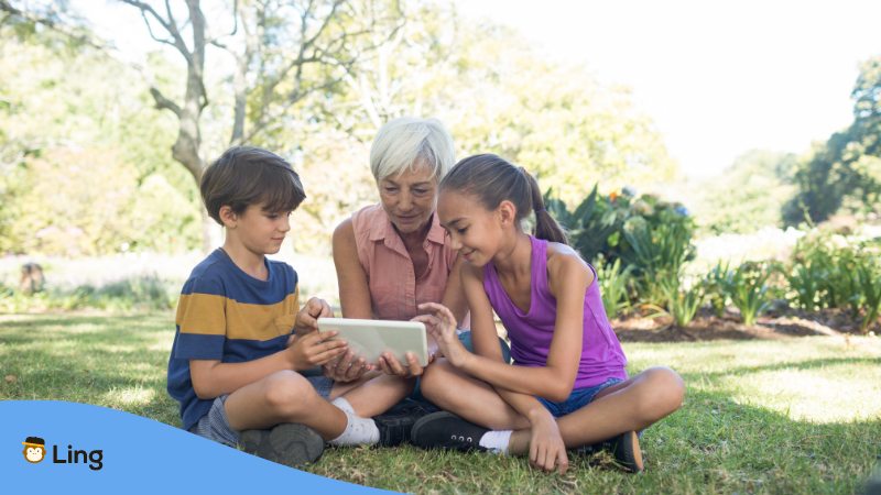 Kids with their grandma using their Kindle Edition to learn politeness.