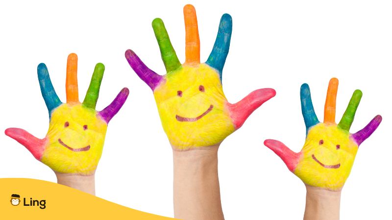 children's hands painted with smily face