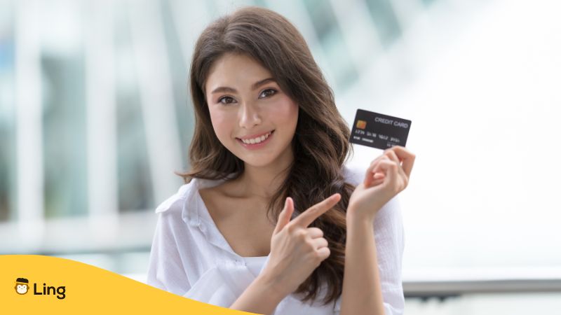 woman holding a bank card