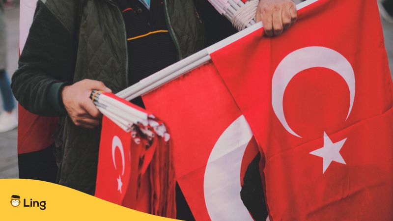 Man holding a bunch of flags - Turkish Flag - Ling