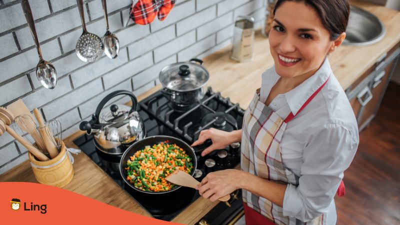 What Is Kitchen In German - woman cooking 