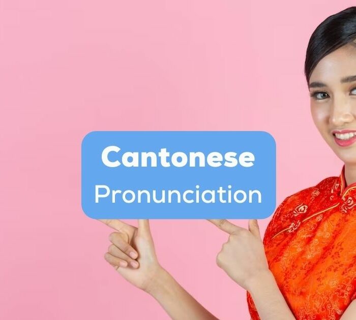 A beautiful Chinese girl pointing to Cantonese pronunciation text.