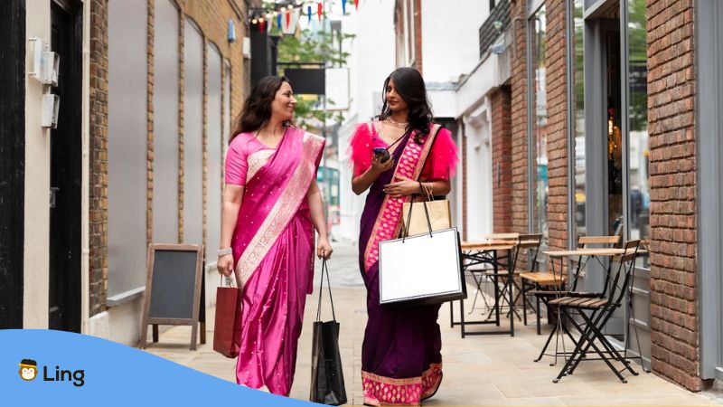 Two women from Indian population speak Punjabi walking on the street talking about the word Punjabi saanu ki literal meaning
