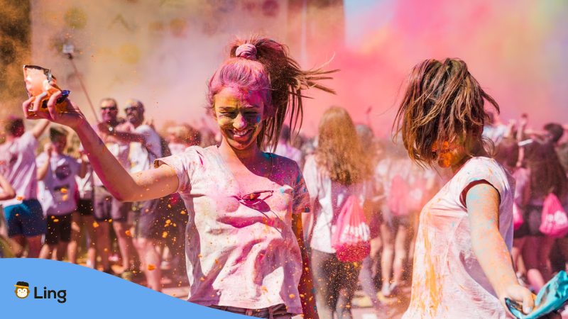 A photo of two young women playing and enjoying Holi colors in India.