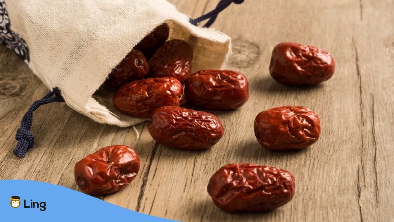 A photo of dried Indian jujubes on a wooden table.