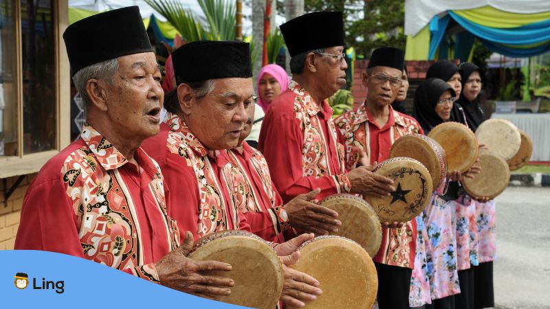 A group of old Malaysian men playing Kompangs.