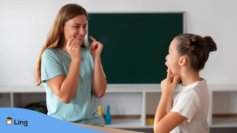 A language tutor teaches a learner proper pronunciation.