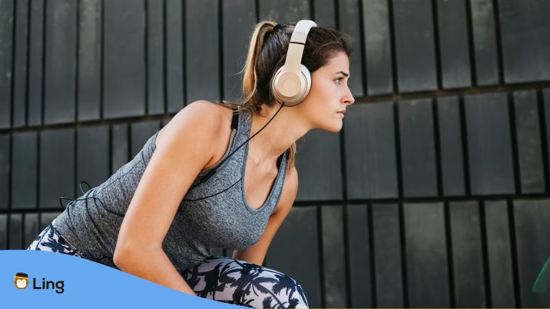 A young woman in an urban sports concept with a headphone.