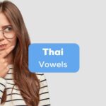 A photo of a girl with glasses confused about Thai vowels.