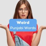 A confused pretty lady with glasses in red shirt behid the weird Punjabi words texts.