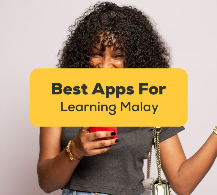 Best Apps For Learning Malay - A photo of a female with a curly hair using her phone