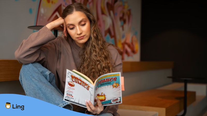 A long-haired female reading Korean comics to expand her understanding of the Korean writing systems.