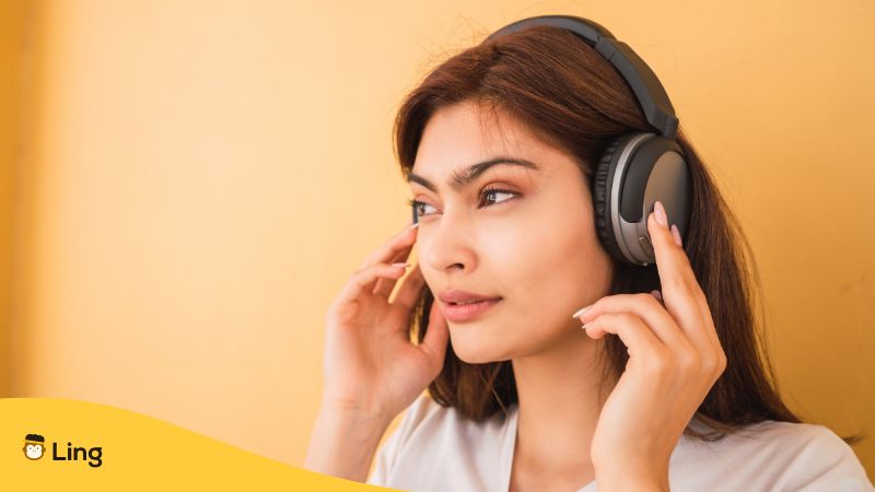 woman listening to music - Top German Songs For Beginners
