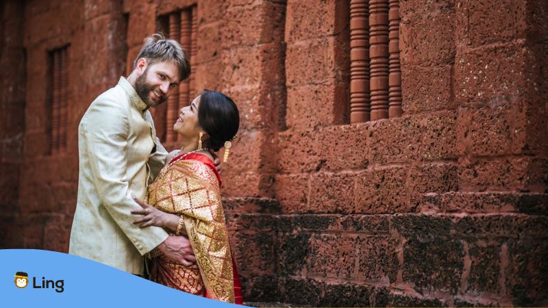 Dating In Punjabi Regions - A Western man dating a Punjabi girl in front of a brick wall.
