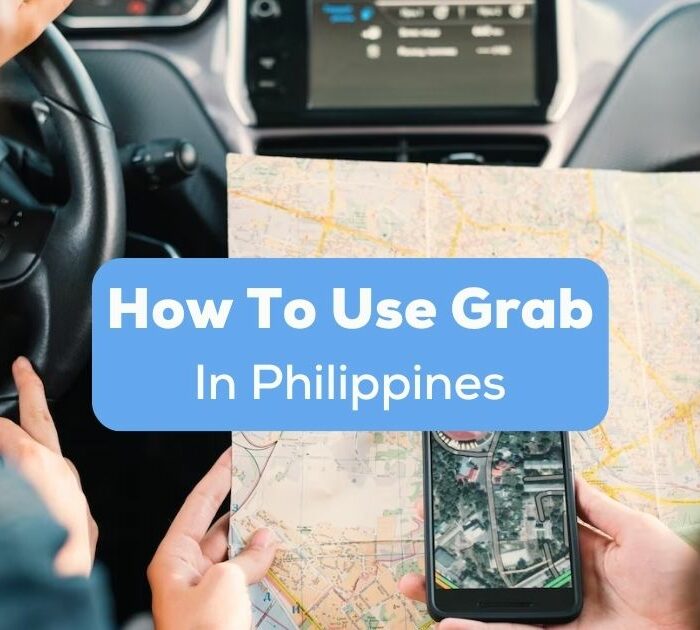 A photo of a driver and a passenger inside a car with a map and mobile phone learning how to use Grab in Philippines.