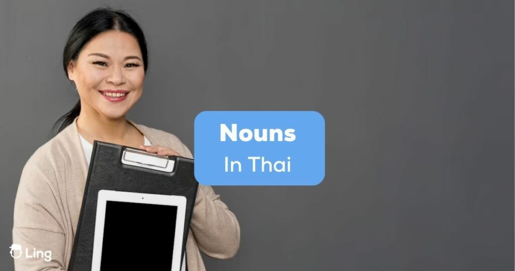 A happy female holding an iPad beside the nouns in Thai texts.