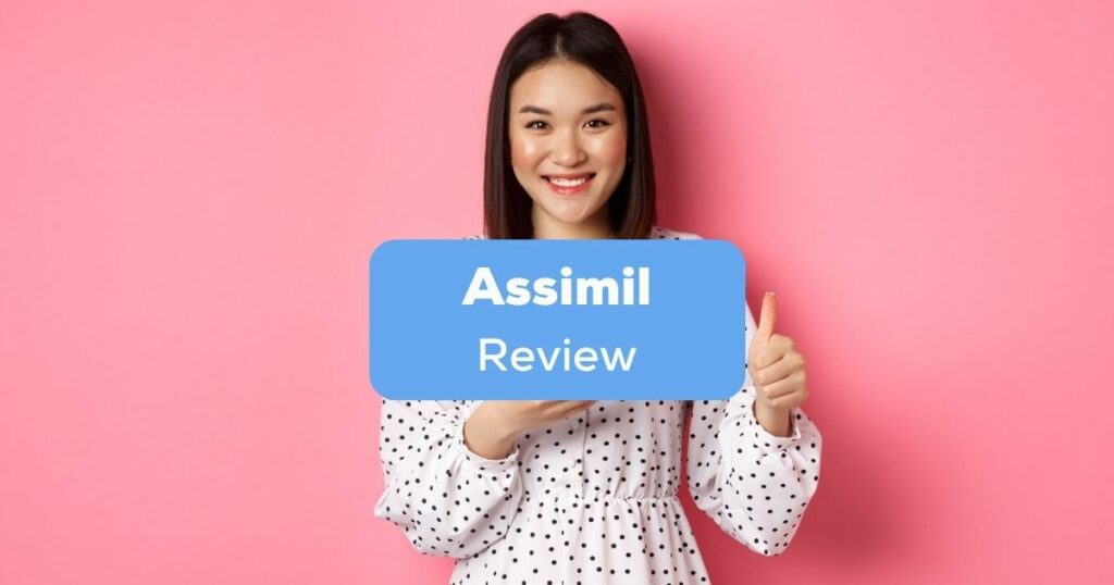 A pretty smiling Asian girl doing a thumbs up sign behind the Assimil review texts.