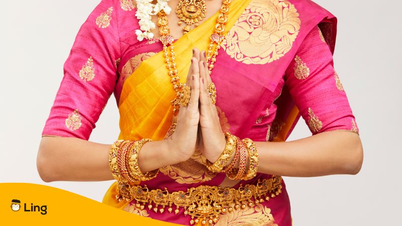 greetings in tamil - person with both hands together as a greeting