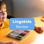 A young boy with his headphones on, learning inside his room in front of a laptop behind the Lingokids review texts.