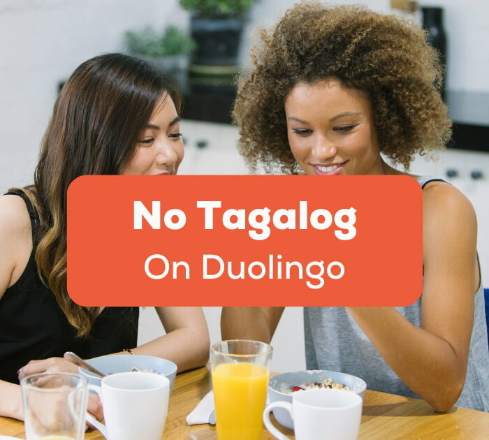 No Tagalog On Duolingo - A photo of two women looking at a phone having drinks