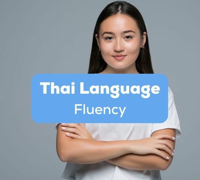 A confident-looking Asian girl with her arms crossed behind the Thai language fluency texts.