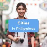 A female tourist in a busy street holding a camera behind the cities in Philippines texts.