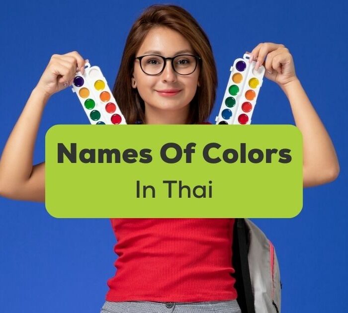 names of colors in Thai - A photo of a woman holding coloring tools