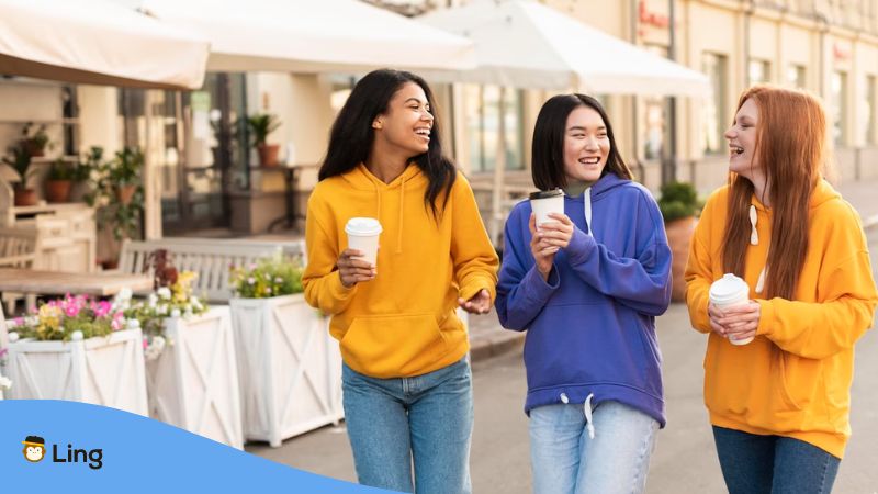 A photo of a Cantonese female with her foreign friends walking in the street in Australia.