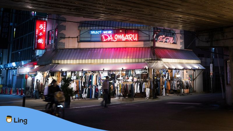 A photo of a clothing market still open at night as part of Korean shopping culture.