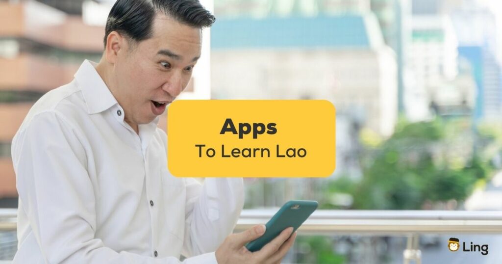apps to learn Lao - A photo of a man enjoys using his mobile phone outside