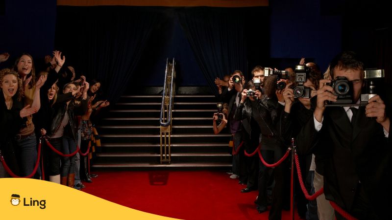 photographers at the sides of a red carpet waiting for celebrities