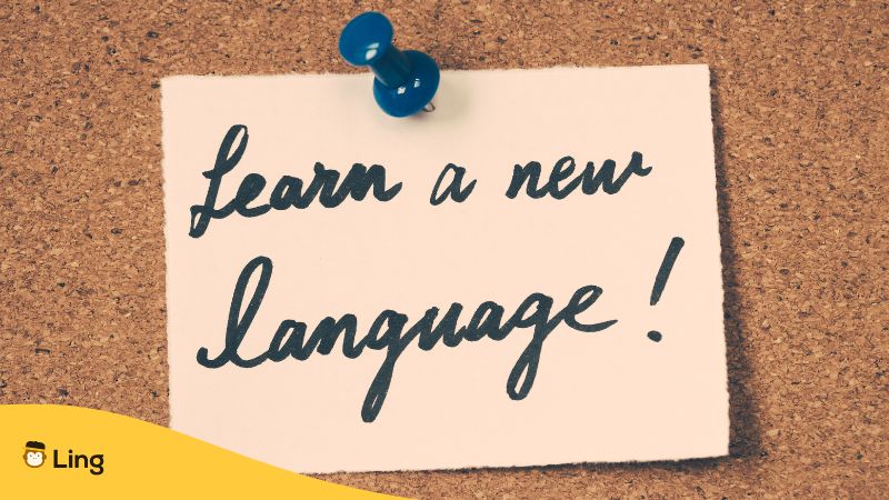 learn a new language written on paper and posted to a cork board